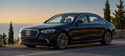 Mercedes S-Class — black executive sedan on a coastal Greek road