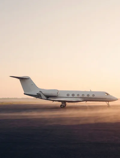 Private jet on a tarmac at sunrise