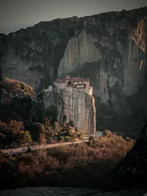 A monastery on the Meteora rock pillars at sunrise